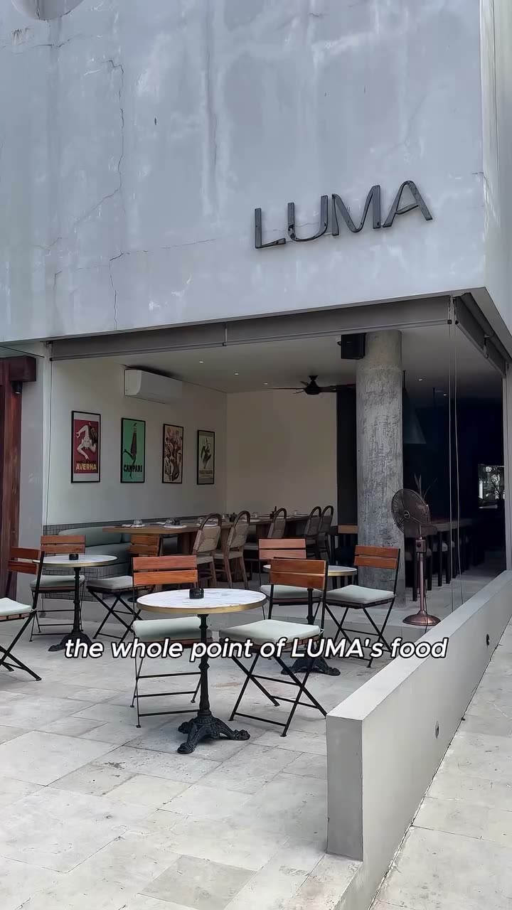 Luma's street frontage on Batu Bolong, the sign above an empty terrace of marble tables in the morning