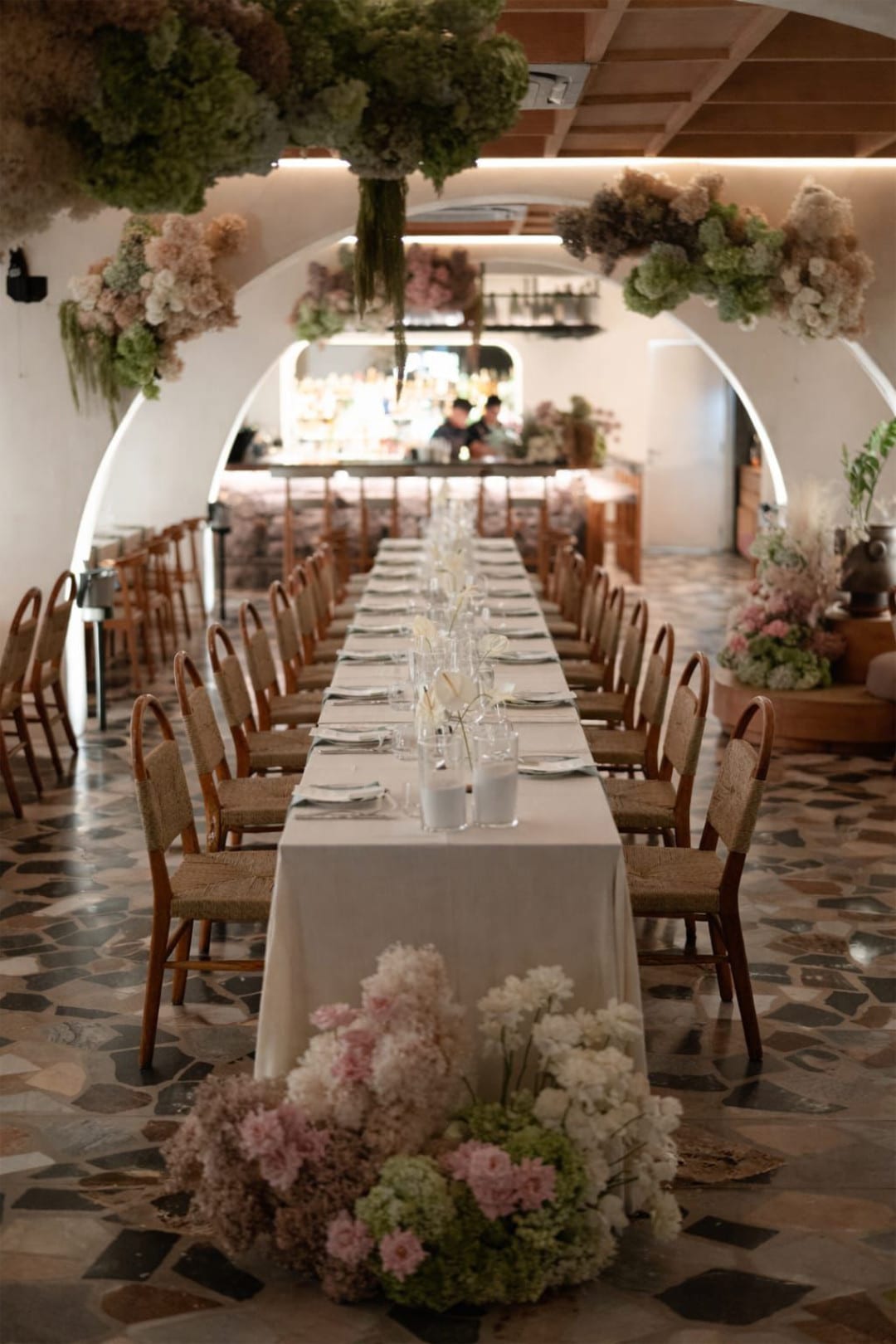 A long table laid the length of Luma's arched dining room, dried flowers hung above it and set along the floor
