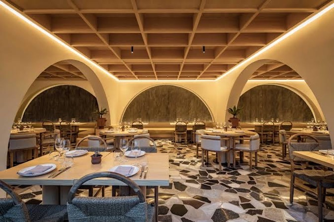 The main dining room, arched banquettes over a terrazzo floor